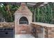 Brick grill in a covered outdoor kitchen at 4952 Creekside Park Ave, Orlando, FL 32811