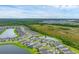 Aerial view of a large community with houses, a lake, and conservation area at 2777 Nature View Rd, Saint Cloud, FL 34771