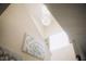Elegant staircase with crystal chandelier and wall art at 1532 Nassau Point Trl, Kissimmee, FL 34747