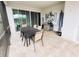Covered patio with dining table, grill, and screened enclosure at 1532 Nassau Point Trl, Kissimmee, FL 34747