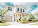 Two-story house with a light-colored facade, a large garage, and landscaping at 1532 Nassau Point Trl, Kissimmee, FL 34747