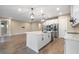 Modern kitchen with white cabinetry, large island, and stainless steel appliances at 1352 Silo Dr, St Cloud, FL 34771