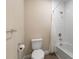 Clean bathroom with toilet, bathtub, shower, and white tile at 1352 Silo Dr, St Cloud, FL 34771