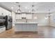 Bright kitchen featuring white cabinets, an island, and stainless steel appliances at 1352 Silo Dr, St Cloud, FL 34771