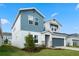 Two-story house with gray and blue siding, stone accents, and a two-car garage at 1352 Silo Dr, St Cloud, FL 34771