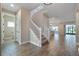 Bright and spacious entryway with tile flooring, staircase, and views to the living area at 1352 Silo Dr, St Cloud, FL 34771