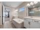 Elegant bathroom featuring a soaking tub and dual vanities at 1352 Silo Dr, St Cloud, FL 34771