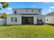 Two-story house with backyard, lawn, and screened patio at 1352 Silo Dr, St Cloud, FL 34771