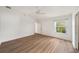 Well-lit bedroom with large window and wood flooring at 2382 Anita Way, The Villages, FL 32162