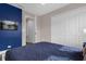 Bedroom with blue walls, a bed, and white closet doors at 4715 Terra Esmeralda Dr, Kissimmee, FL 34746