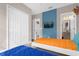 Bedroom with twin bed, blue accent wall and bathroom access at 4715 Terra Esmeralda Dr, Kissimmee, FL 34746