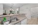 Kitchen with double sink, dishwasher, and view into the living room at 1029 Park Ridge Cir, Kissimmee, FL 34746