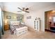 Bright bedroom with a floral bedspread, ceiling fan, and ample closet space at 172 Lago Vista Blvd, Casselberry, FL 32707