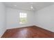 Bright bedroom with hardwood floors and a large window at 3702 Palm Desert Ln # 5431, Orlando, FL 32839