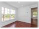 Bright bedroom with hardwood floors and a large window at 3702 Palm Desert Ln # 5431, Orlando, FL 32839
