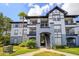 Two-story building exterior with gray and white accents, stairs, and landscaping at 3702 Palm Desert Ln # 5431, Orlando, FL 32839