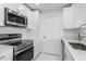 Stainless steel appliances and white shaker cabinets in this galley kitchen at 3702 Palm Desert Ln # 5431, Orlando, FL 32839