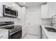 Modern kitchen with white cabinets, stainless steel appliances, and quartz countertops at 3702 Palm Desert Ln # 5431, Orlando, FL 32839