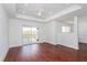 Bright living room with hardwood floors, sliding door to balcony, and ceiling fan at 3702 Palm Desert Ln # 5431, Orlando, FL 32839