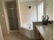 Large bathroom with a corner soaking tub and walk-in shower at 238 Carrera Ave, Davenport, FL 33897