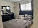 Bedroom with a double bed, dresser, and window coverings at 238 Carrera Ave, Davenport, FL 33897