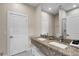 Bathroom with granite countertop, double sinks, and modern fixtures at 3243 Brasilia Ave, Kissimmee, FL 34747