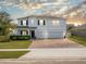 Two-story home with a three-car garage and landscaped lawn at 1511 Orange Valley Rdg, Ocoee, FL 34761