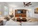 Bright living room featuring a comfortable sofa and built-in entertainment center at 1511 Orange Valley Rdg, Ocoee, FL 34761