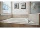 Relaxing bathroom with a large soaking tub and neutral tile at 1511 Orange Valley Rdg, Ocoee, FL 34761