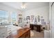 Cozy bedroom with a desk and a wall filled with various pictures and artwork at 1511 Orange Valley Rdg, Ocoee, FL 34761