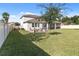 Large backyard with grassy area and screened patio at 1511 Orange Valley Rdg, Ocoee, FL 34761