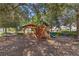 Wooden playground structure with slides and a shaded area at 1511 Orange Valley Rdg, Ocoee, FL 34761