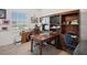 Home office with large desk and built-in wooden shelving unit at 1511 Orange Valley Rdg, Ocoee, FL 34761