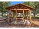Wooden gazebo with picnic tables overlooking a lake at 1511 Orange Valley Rdg, Ocoee, FL 34761