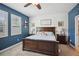 Serene bedroom with a king-size bed and calming blue walls at 1511 Orange Valley Rdg, Ocoee, FL 34761