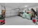 Garage with open door, storage items, and flooring at 1093 Berry Ln, Davenport, FL 33837