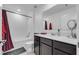 Clean bathroom with dark brown vanity and shower/tub combo at 1093 Berry Ln, Davenport, FL 33837