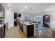 Modern kitchen with island, stainless steel appliances, and dark cabinets at 1093 Berry Ln, Davenport, FL 33837