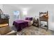 Bedroom with purple bedding and a wooden desk at 1093 Berry Ln, Davenport, FL 33837