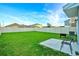 Grass backyard with patio and grill at 1093 Berry Ln, Davenport, FL 33837
