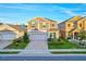 Two story home with grey siding and a two car garage at 1093 Berry Ln, Davenport, FL 33837