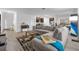 Living room with L-shaped sofa, coffee table, and area rug at 1093 Berry Ln, Davenport, FL 33837