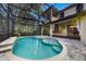 Stunning kidney shaped pool with a screened enclosure and water feature at 600 Via Chris Ct, Debary, FL 32713