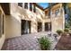 Brick paved patio with two stone benches and potted plants at 600 Via Chris Ct, Debary, FL 32713