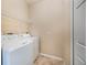 Functional laundry room with washer, dryer, and overhead shelving at 600 Via Chris Ct, Debary, FL 32713
