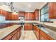 Kitchen features granite countertops, stainless steel appliances, and ample wood cabinets at 600 Via Chris Ct, Debary, FL 32713