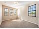 Bright bedroom with neutral walls and carpet, featuring multiple windows with blinds at 600 Via Chris Ct, Debary, FL 32713