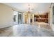 Open living room with tile floors and views into kitchen and dining areas at 600 Via Chris Ct, Debary, FL 32713