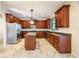 Spacious kitchen with dark wood cabinets, granite counters, and stainless steel appliances at 600 Via Chris Ct, Debary, FL 32713