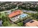Aerial view of community pool with surrounding homes and landscaping at 600 Via Chris Ct, Debary, FL 32713